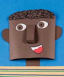 Colorful paper craft face with curly hair and cheerful expression on blue background