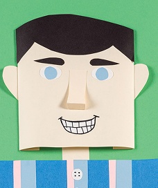 Paper craft character with a smiling face and striped shirt on green background