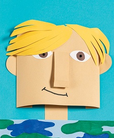 Paper craft artwork depicting a smiling boy with blonde hair and simple features.