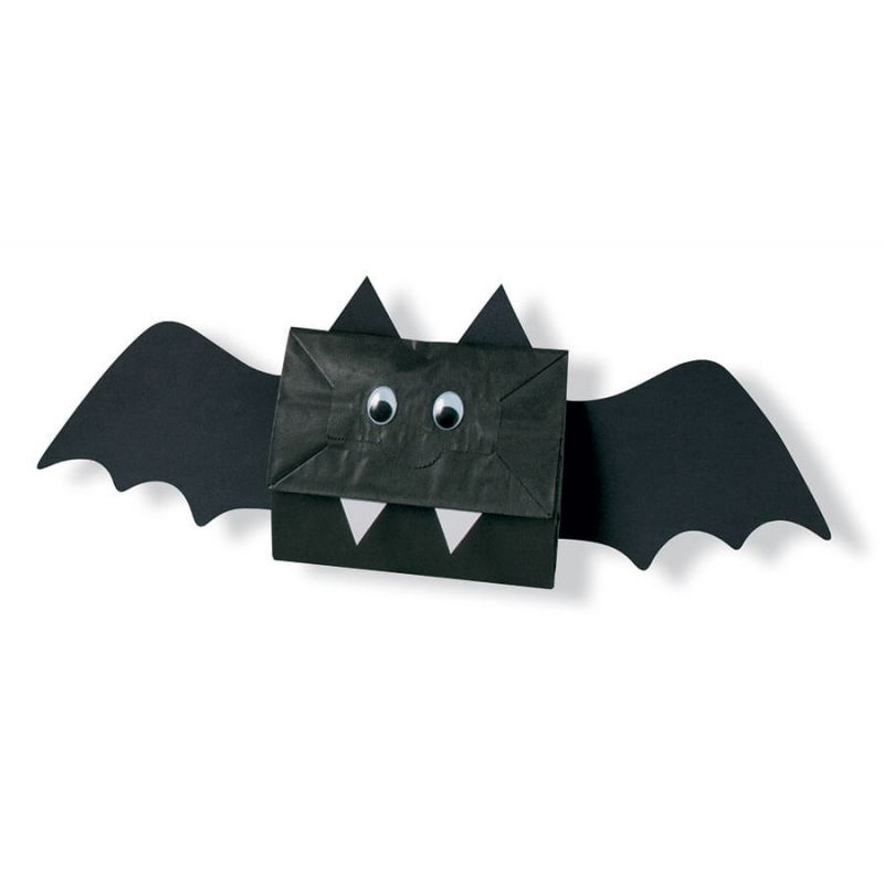 Crafted paper bat with googly eyes and sharp teeth for Halloween decoration.