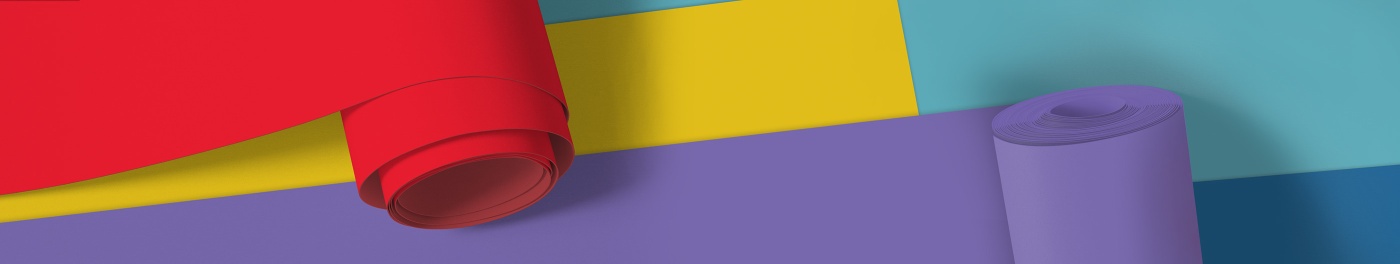 Colorful rolled paper in vibrant hues of red, yellow, and purple.